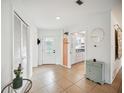 Bright and airy entryway with tile flooring and view of kitchen at 530 Saint Andrews Dr, Sarasota, FL 34243