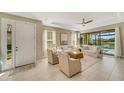 Bright living room with white couches and sliding doors at 5341 Popoli Way, Sarasota, FL 34238