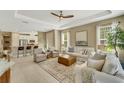 Open living room and kitchen with neutral decor at 5341 Popoli Way, Sarasota, FL 34238
