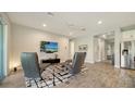 Relaxing living room features leather recliners and large TV at 5436 Hope Sound Cir, Sarasota, FL 34238