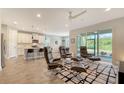 Spacious living room with leather seating and view into kitchen at 5436 Hope Sound Cir, Sarasota, FL 34238