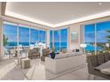 Spacious living room with floor-to-ceiling windows and water views at 555 Quay Cmn # 905, Sarasota, FL 34236