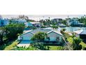 Beautiful waterfront home with mature tropical landscaping and a charming tile roof at 6011 Emerald Harbor Dr, Longboat Key, FL 34228