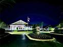 Night view of community clubhouse entrance with landscaping at 6501 Stone River Rd # 203, Bradenton, FL 34203