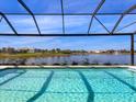 Relaxing pool with screened enclosure and lake view at 8436 Cane Bay Ct, Lakewood Ranch, FL 34202