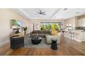 Bright living room with hardwood floors, comfortable seating, and access to a backyard view at 942 Preservation St, Bradenton, FL 34208