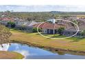 Property showcasing a home with pool and lanai, overlooking a tranquil lake at 963 River Wind Cir, Bradenton, FL 34212