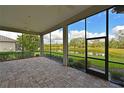 Spacious screened lanai with paver floor and peaceful lake view at 963 River Wind Cir, Bradenton, FL 34212
