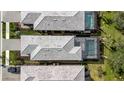 Aerial view showcasing two houses with pools and surrounding landscaping at 10358 Abaco Falls Dr, Englewood, FL 34223
