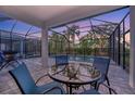 Relaxing pool area with covered patio and seating at 10358 Abaco Falls Dr, Englewood, FL 34223