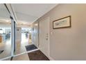 Bright condo entry with mirrored closet doors and view of living area at 1200 E Peppertree Ln # 307, Sarasota, FL 34242