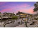 Covered boat lift and dock with sunset views at 4611 Shark Dr, Bradenton, FL 34208