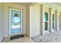 Inviting entryway with a decorative glass door and large windows allowing for ample natural light at 482 Rubens Dr E, Nokomis, FL 34275