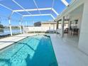 Sparkling pool in screened enclosure overlooking the serene lake at 5307 52Nd W Ave, Bradenton, FL 34210
