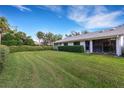 Spacious backyard with well-manicured lawn and hedge at 5535 Hampstead Heath # 45, Sarasota, FL 34235