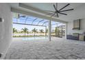 Expansive screened patio with an outdoor kitchen overlooking the pool and scenic water view at 8328 Sea Glass Ct, Sarasota, FL 34240
