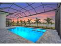 Stunning pool and spa with a screened enclosure and water view offering a luxurious outdoor living space at 8328 Sea Glass Ct, Sarasota, FL 34240