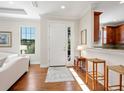 Bright entryway with hardwood floors and view into living room and kitchen at 8752 Bellussi Dr, Sarasota, FL 34238