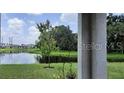 Partial view of pond from covered patio, showcasing serene backyard at 9016 Waxwing Way, Parrish, FL 34219