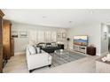 Living room with comfortable couches, a large TV, and coastal-themed decor at 1125 N Moonmist Ct # L5, Sarasota, FL 34242