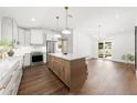 Bright and airy kitchen featuring an island, stainless steel appliances, and hardwood flooring at 2326 Gull Ln, Sarasota, FL 34237