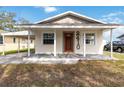 Updated bungalow exterior with a covered porch and a well-maintained lawn at 2410 13Th W St, Palmetto, FL 34221