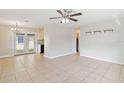 Open living area with tile floors and access to the kitchen and patio at 2410 13Th W St, Palmetto, FL 34221