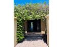 Inviting front entrance adorned with flowering vines, leading into a home with character at 2961 Homasassa Rd, Sarasota, FL 34239