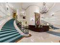 Elegant lobby with grand staircase, chandelier, and reception desk at 35 Watergate Dr # 804, Sarasota, FL 34236