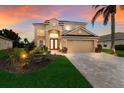 Two-story house with a tan exterior, two-car garage, and landscaped yard at 3618 Summerwind Cir, Bradenton, FL 34209