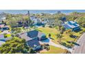 Waterfront property showcasing a single-story home with lush landscaping at 3808 El Conquistador Pkwy, Bradenton, FL 34210