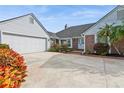 Brick and white home with two-car garage and landscaped front yard at 3808 El Conquistador Pkwy, Bradenton, FL 34210