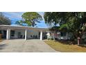 Front view of home with carport and American flag at 3935 Panola Ln # 183, Sarasota, FL 34232