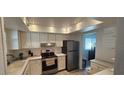 Clean and efficient kitchen with white cabinets at 3935 Panola Ln # 183, Sarasota, FL 34232