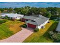 Single story home with a pool and canal view in a residential neighborhood at 4423 Meadow Creek Cir, Sarasota, FL 34233