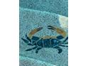 Pool bottom detail featuring a blue crab tile and a textured concrete-style surround at 4423 Via Del Villetti Dr, Venice, FL 34293