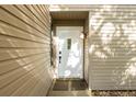 White front door with sidelights and light brown siding at 5311 Creek Dr, Sarasota, FL 34231
