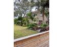 Landscaped yard with wood fence and lush greenery at 5311 Creek Dr, Sarasota, FL 34231