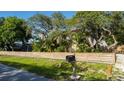 House with wood fence, mailbox, and landscaping at 5311 Creek Dr, Sarasota, FL 34231