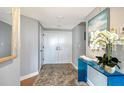 Inviting foyer featuring wood-look flooring and a stylish blue console table at 575 Sanctuary Dr # A303, Longboat Key, FL 34228