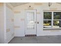 White front door with glass panels and a simple design at 7720 Judith Cres, Port Richey, FL 34668