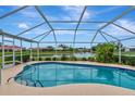 Inviting kidney-shaped pool with screened enclosure offering water views at 1200 Covey Ct, Venice, FL 34293