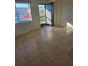 Bright living room with tile flooring and view of exterior at 1313 54Th E Ave # 1313, Bradenton, FL 34203