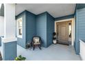 Relaxing front porch with rocking chair and decorative plants at 13930 Old Creek Ct, Parrish, FL 34219