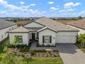 Beautiful single-story home with a well-maintained lawn, neutral stucco, and lovely landscaping at 14587 Bald Cypress Way, Nokomis, FL 34275