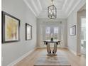 Bright and spacious entryway with hardwood floors and a round glass table at 15415 Derna Ter, Bradenton, FL 34211
