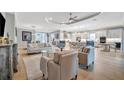 Open living room with light leather sofas and a view into the kitchen at 15415 Derna Ter, Bradenton, FL 34211