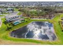 Aerial view of private pool, lanai and serene pond reflecting the sky at 15815 Tradewind Ter, Bradenton, FL 34211