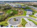 Birds-eye view of a luxury home community with pond and landscaping at 15815 Tradewind Ter, Bradenton, FL 34211