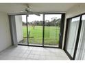 Bright sunroom with tiled floor and sliding glass doors opening to a grassy yard at 4604 Longwater # 77, Sarasota, FL 34235